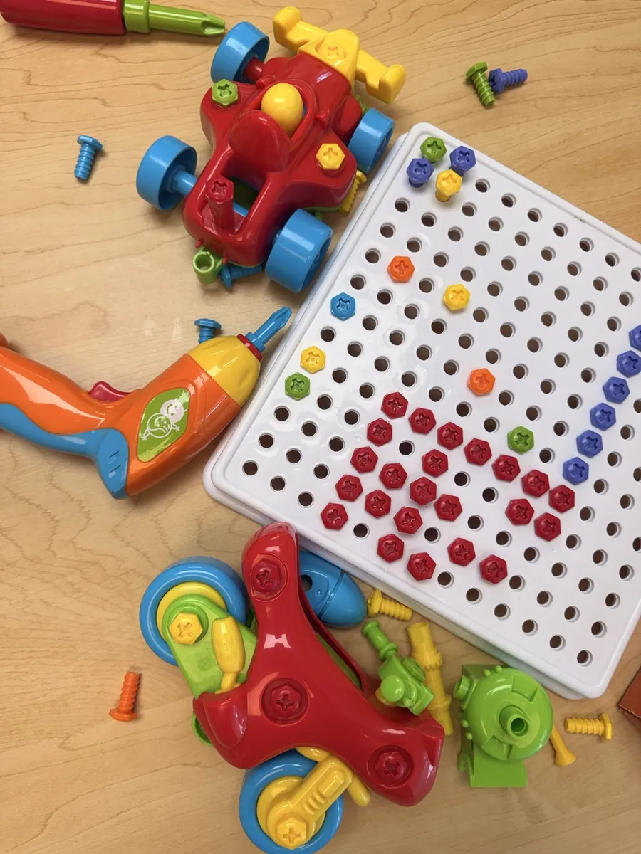Toy drill and building set with colorful screws and pegboard
